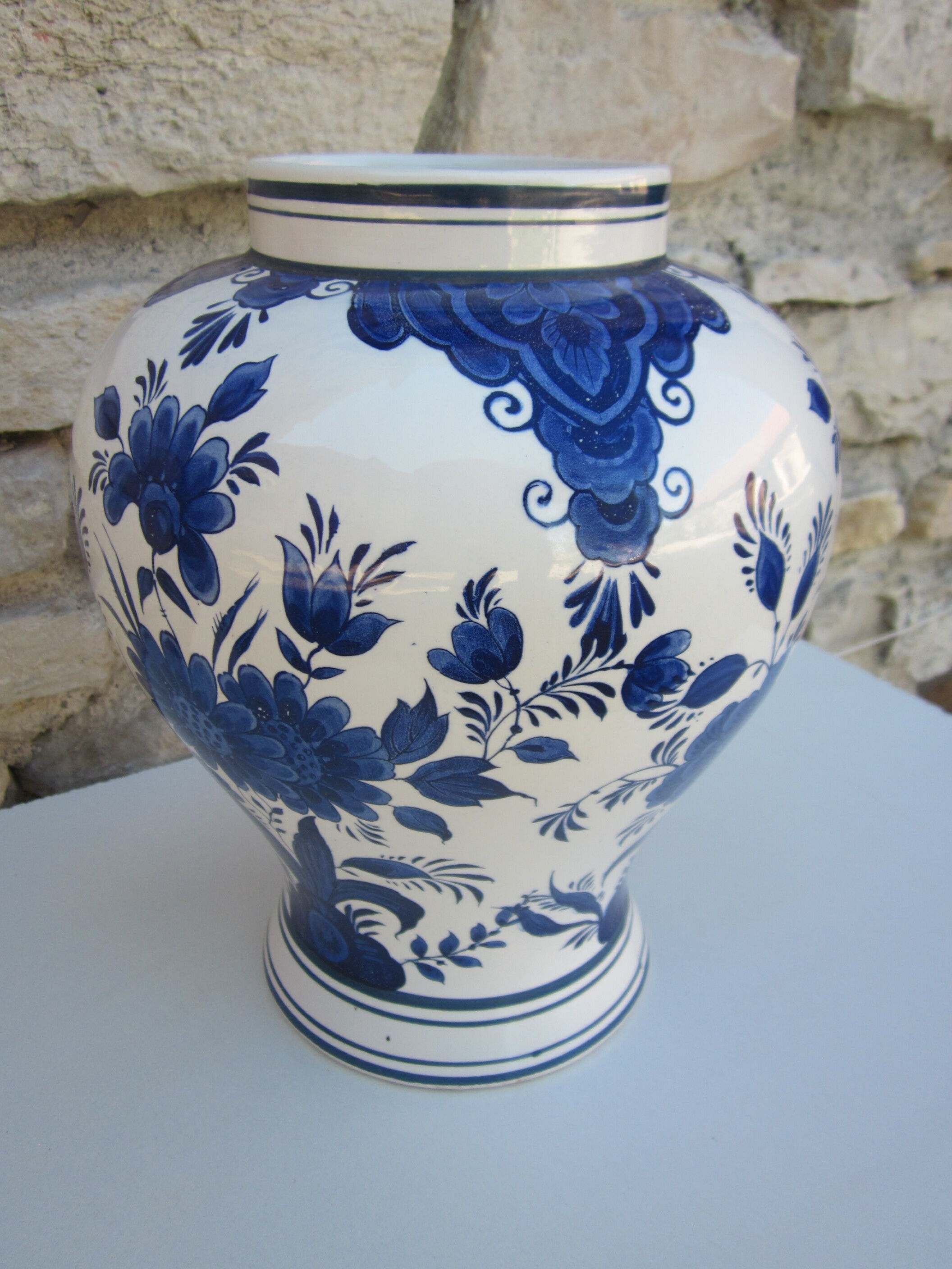 Ceramic vase earthenware, blue floral decoration on a white background