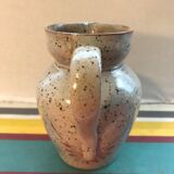 Old gray pitcher with black drawings and vintage stamped handle