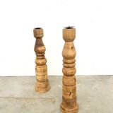 Pair of turned wooden candlesticks, raw and waxed.