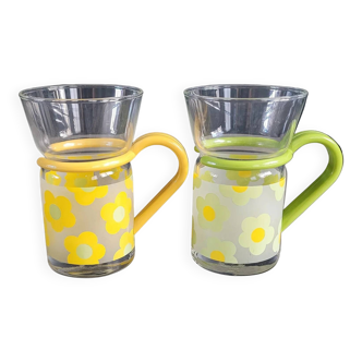 Pair of glass teacups with plastic handles