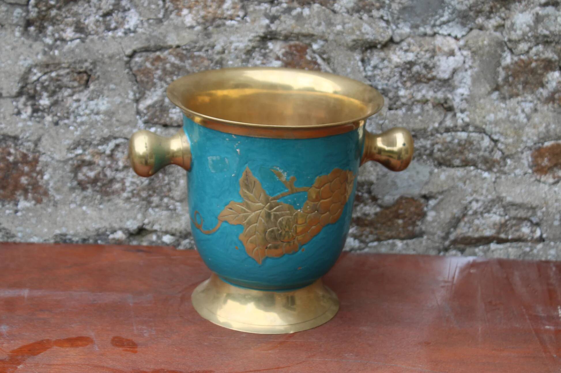 Vintage turquoise brass champagne bucket with grape decoration.