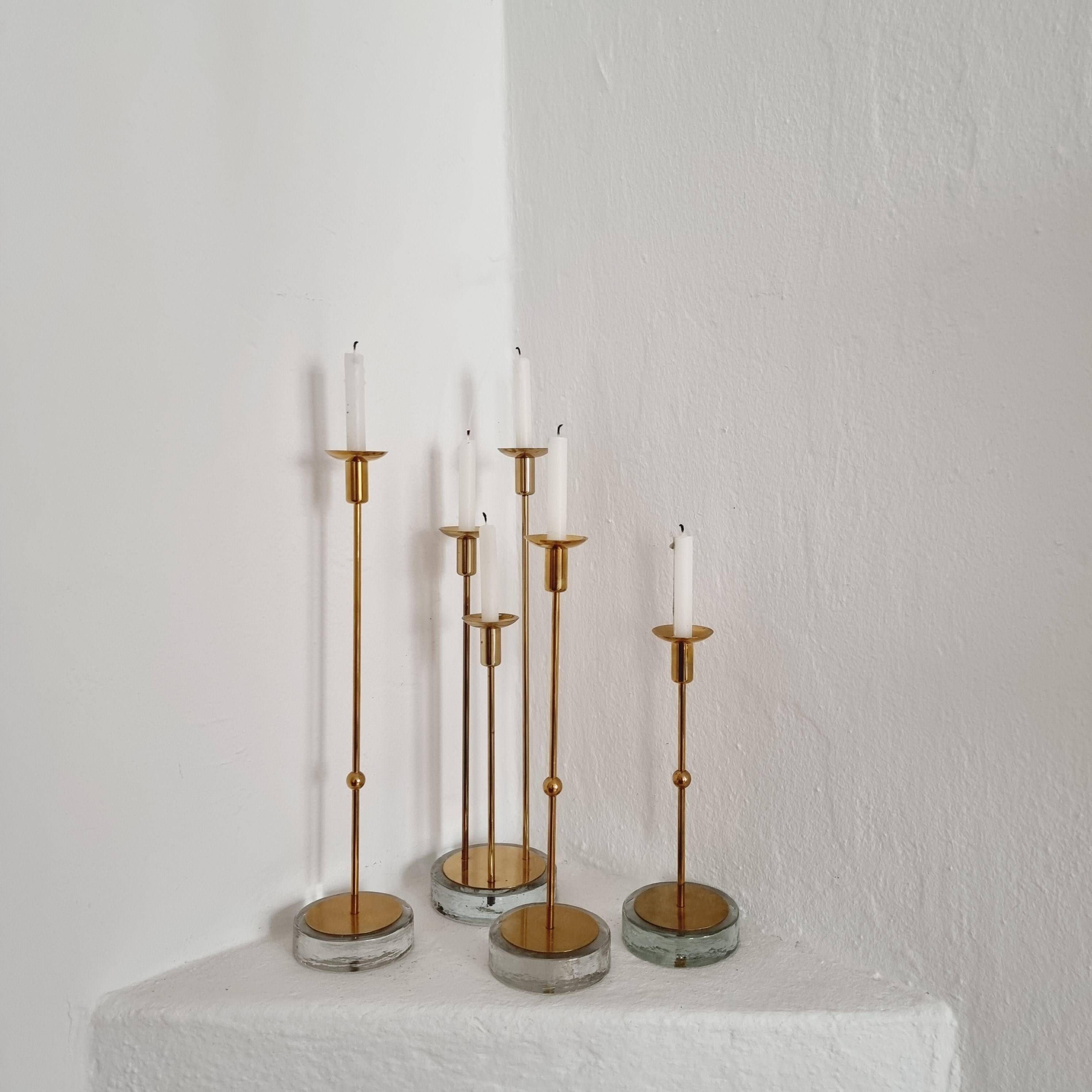Gunnar Ander, four candlesticks, brass and glass, Ystad Metall, Swedish modern.