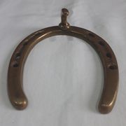Horseshoe-shaped brass coat rack