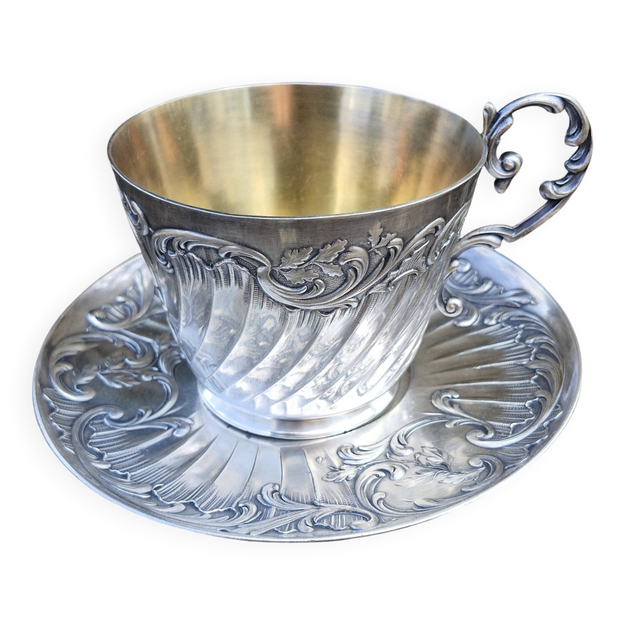 Cup and saucer in solid silver.