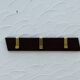 Vintage wooden and brass coat rack with 3 hooks from the 1960s.