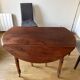 Walnut table with 6 legs and 2 extensions.