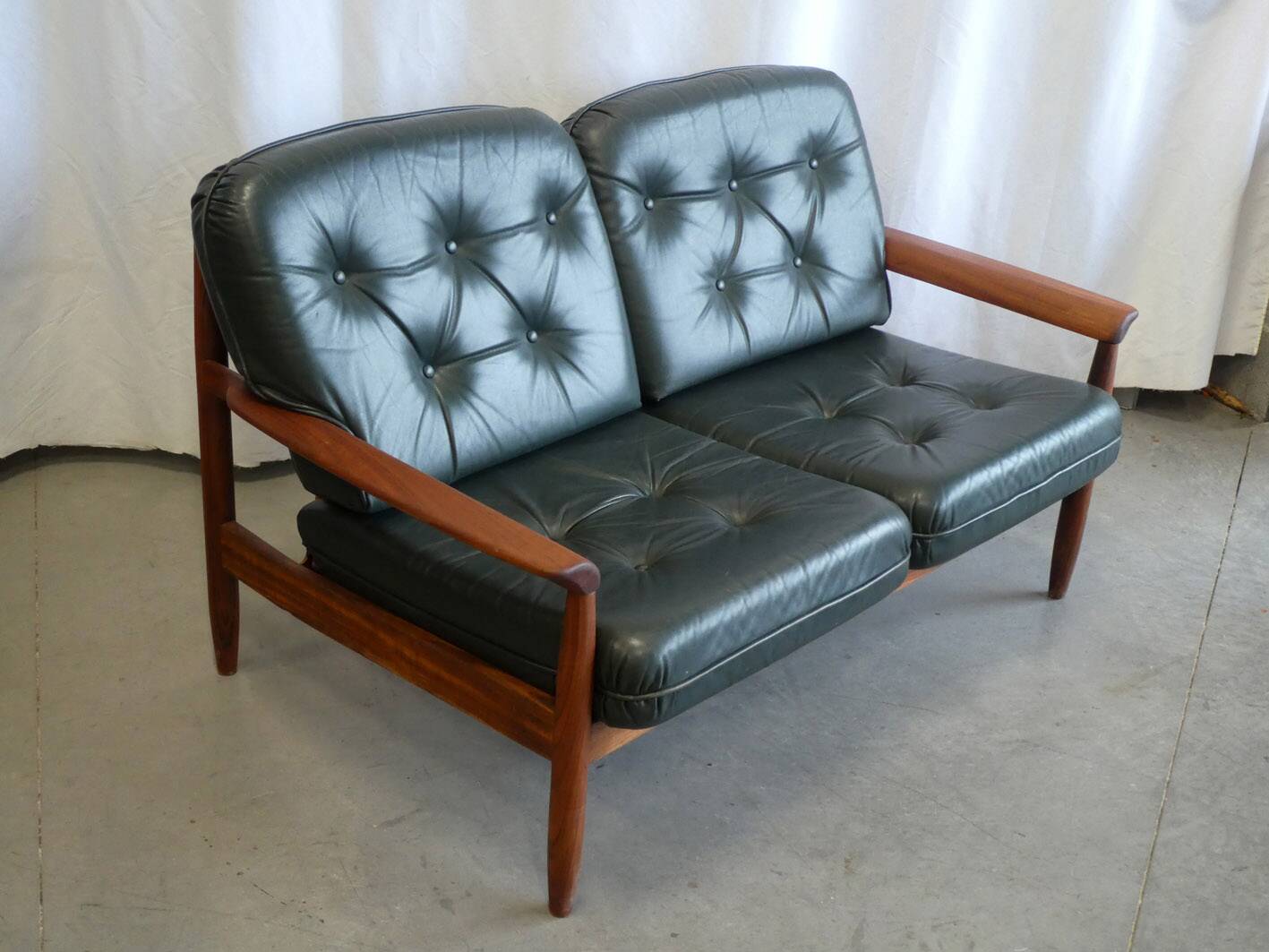 Scandinavian sofa in teak and green leather
