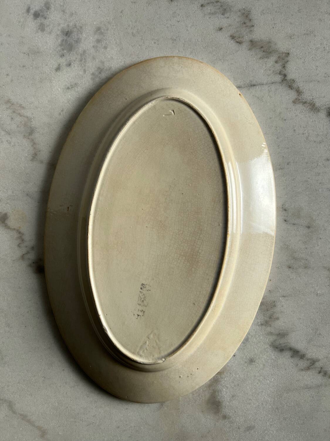 Oval blue presentation plate with birds.