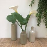 Trio of old sandstone bottles and jars