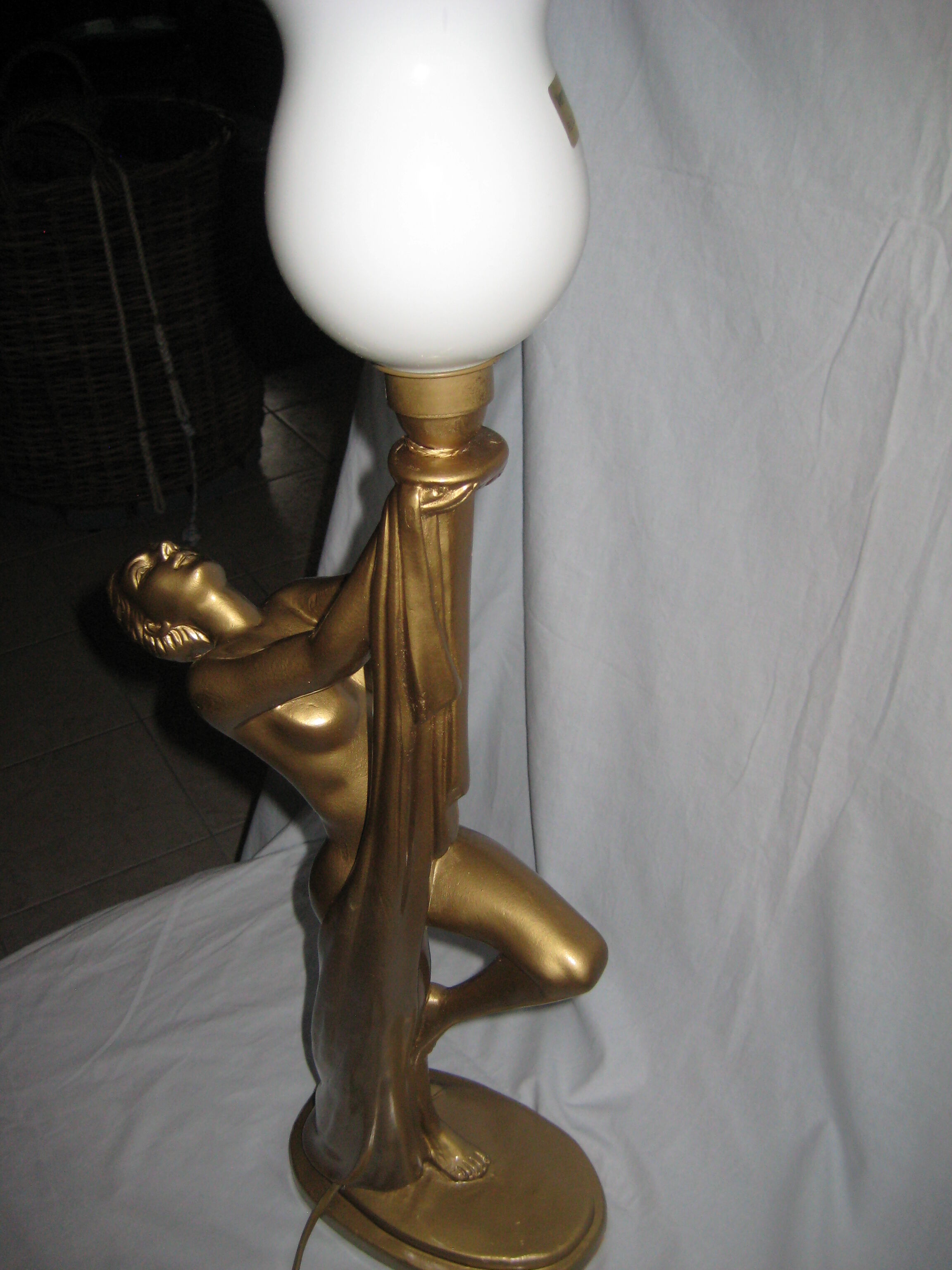 Lamp depicting a with a drape