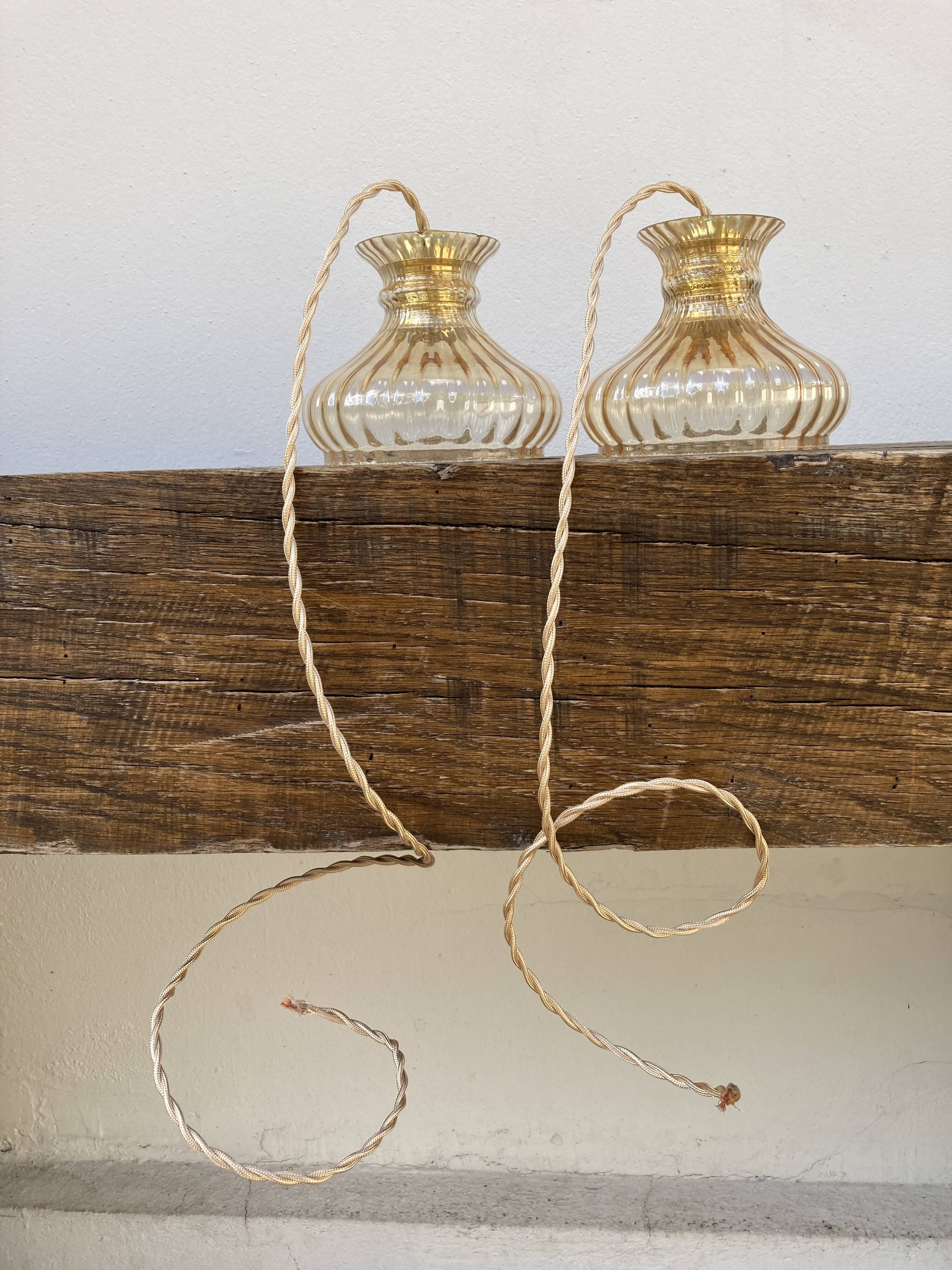 Pair of amber glass walkmen to hang in suspension