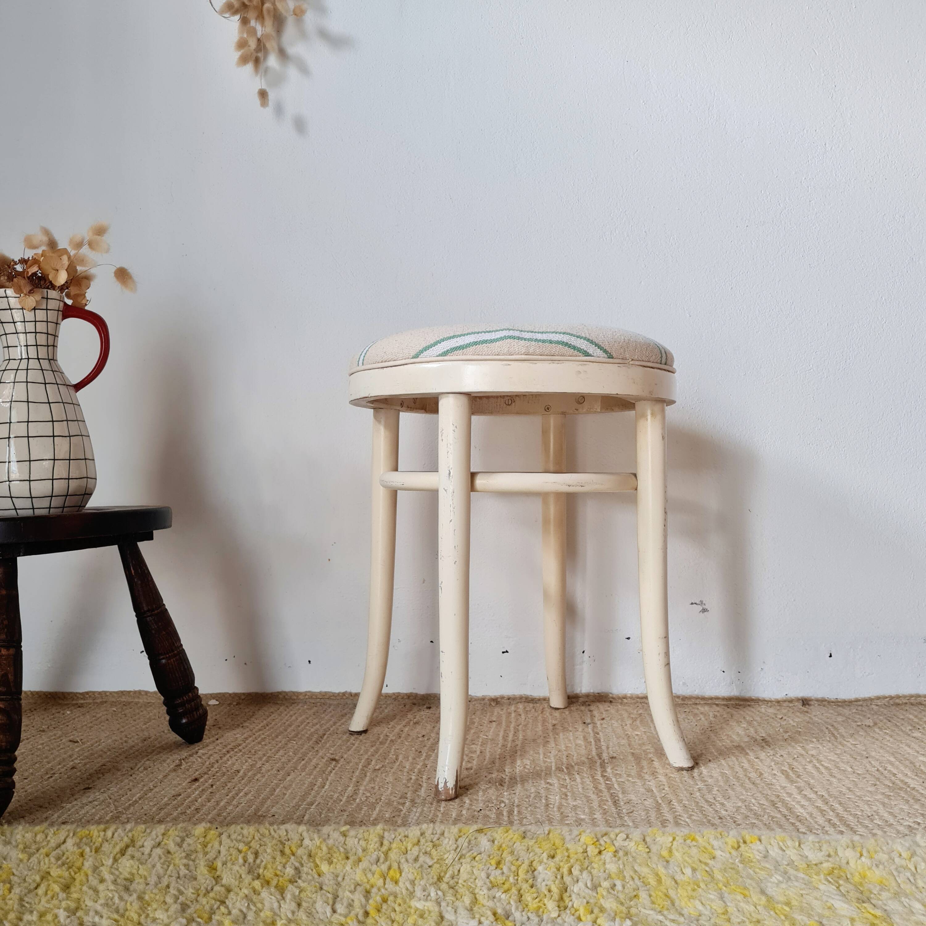 Vintage curved wooden stool in Baumann style, striped fabric seat.