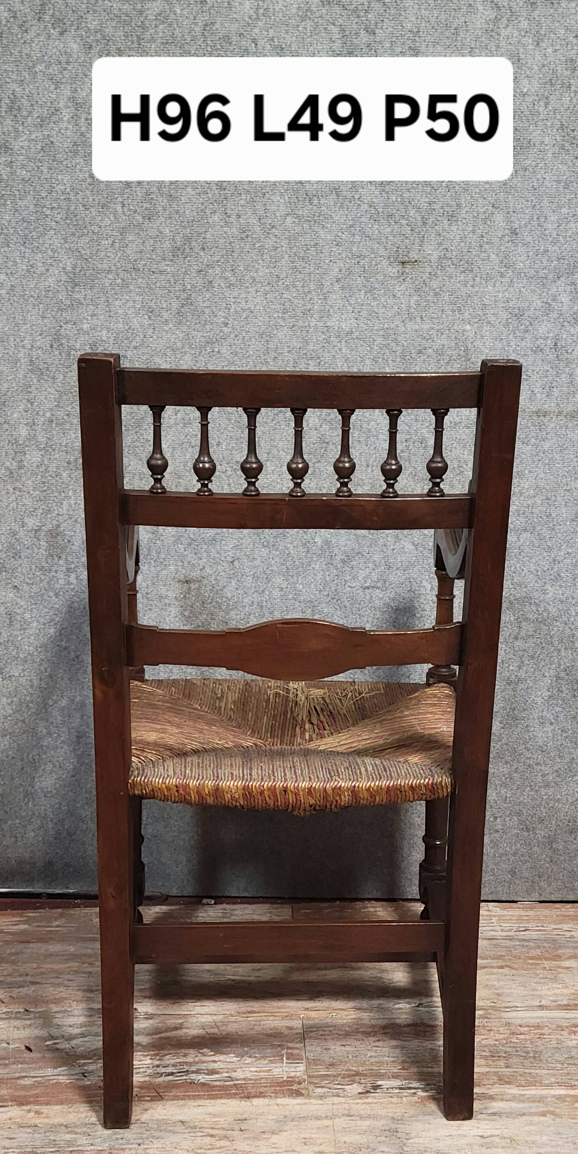 Renaissance-style armchair in solid wood, featuring a columned back