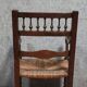 Renaissance-style armchair in solid wood, featuring a columned back