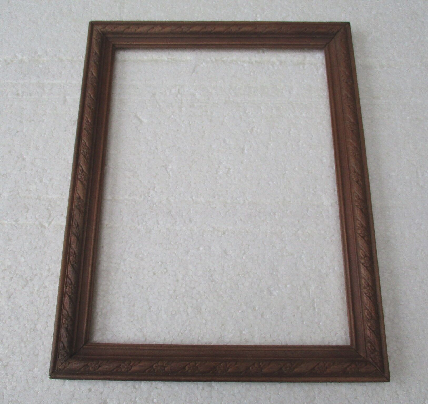 Wooden frame decorated with ribbon and flowers