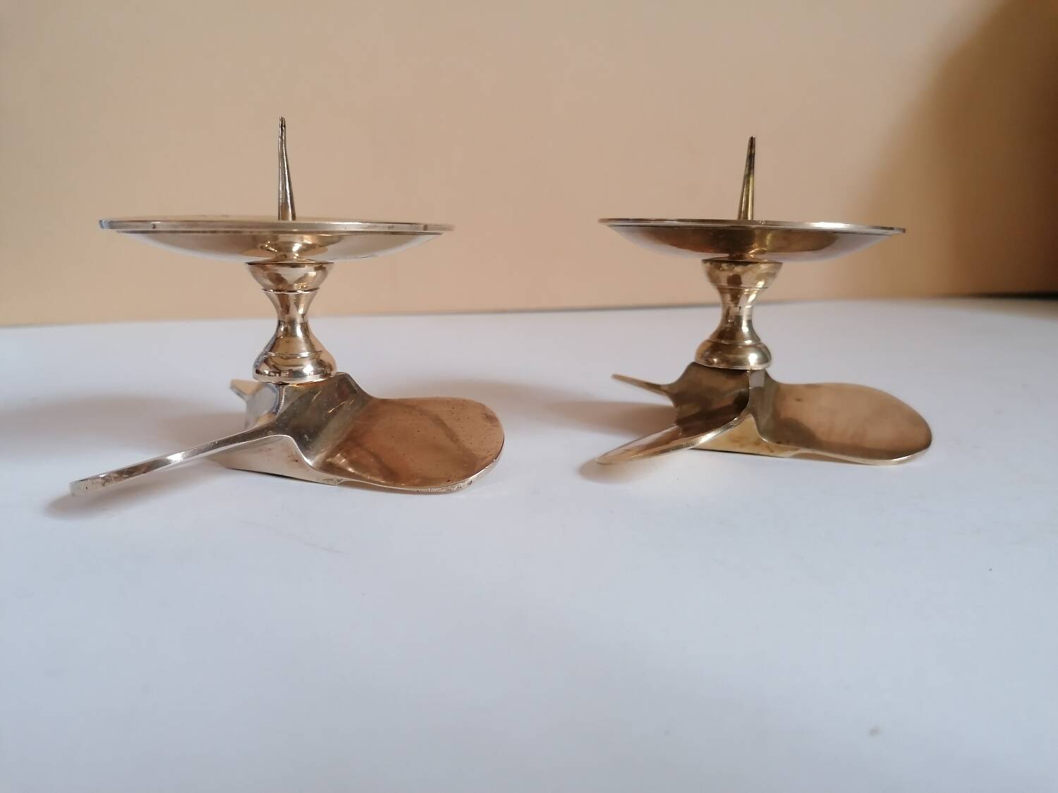 Two brass aviation propeller candle holders