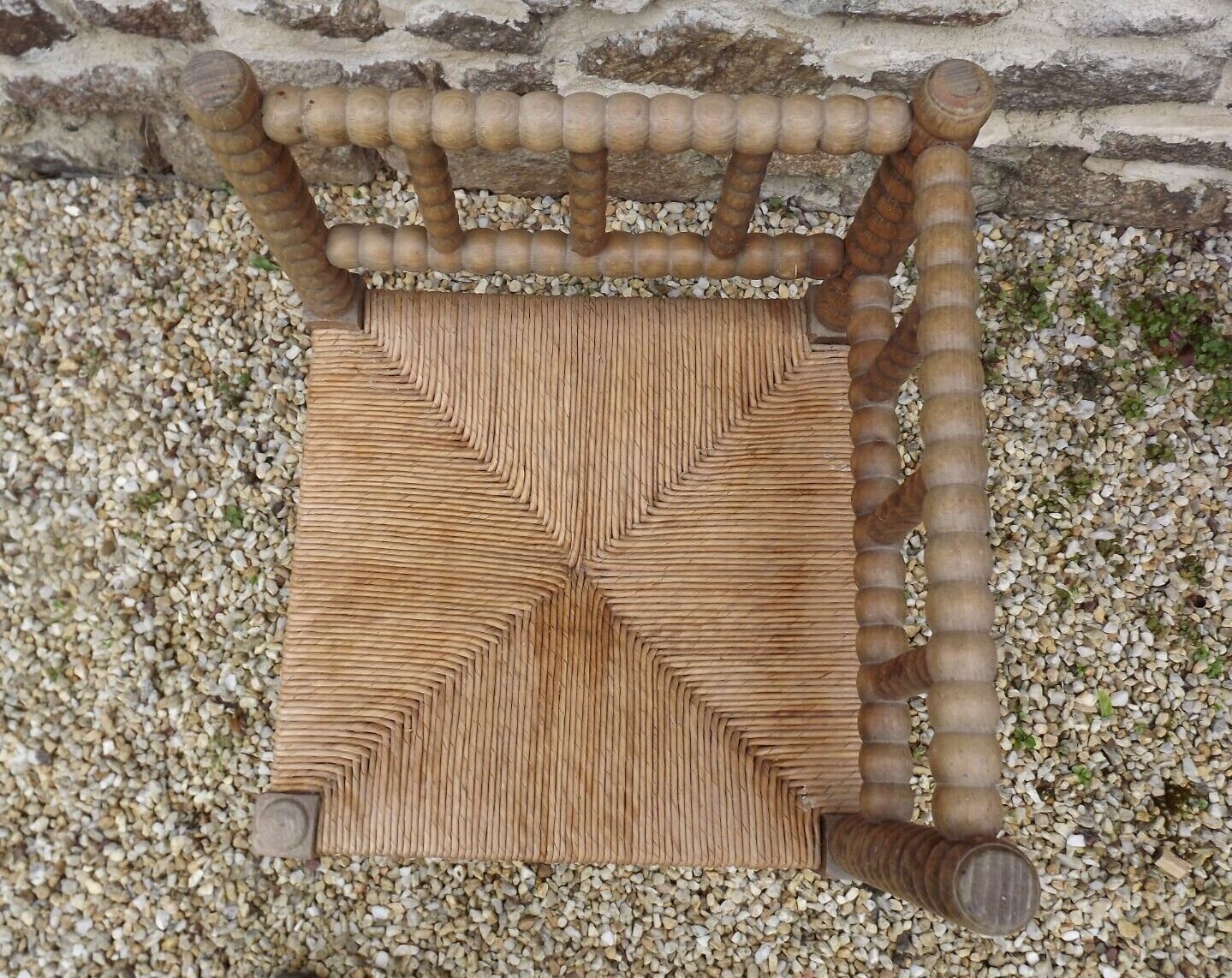 French antique turned wooden bobbin chair with rush seat