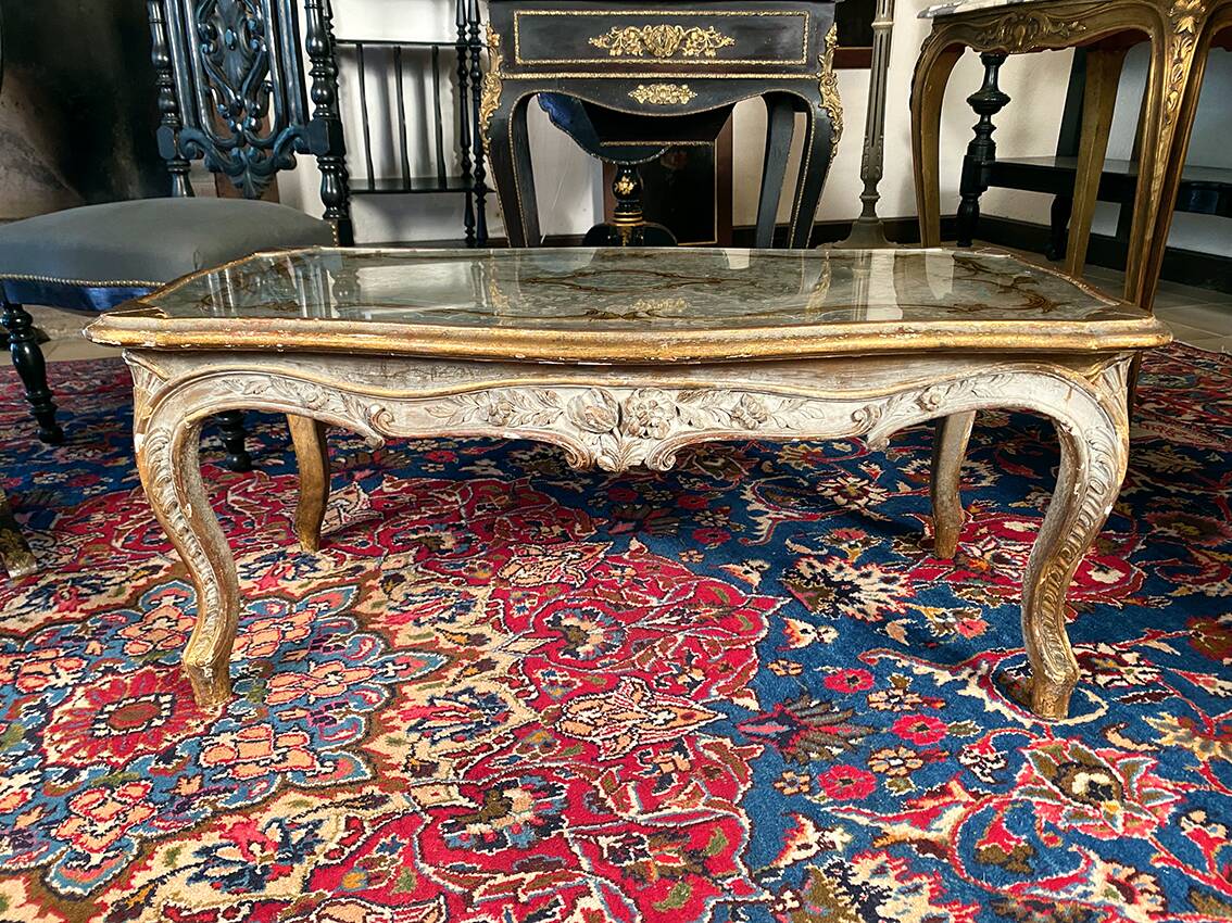 Louis XV style coffee table in carved wood with grey and gold highlights.