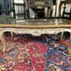Louis XV style coffee table in carved wood with grey and gold highlights.
