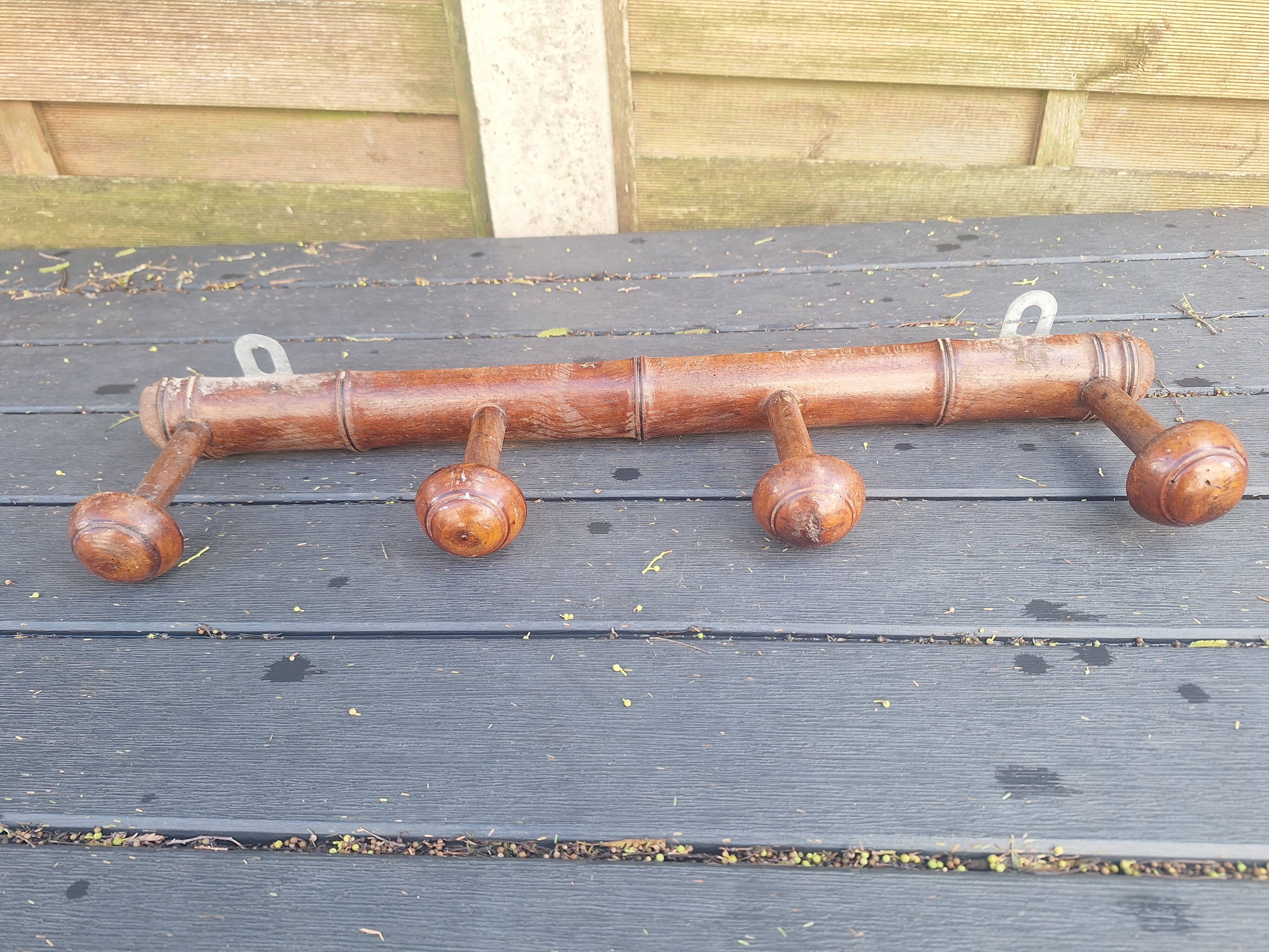 Old wooden coat hook imitating bamboo.