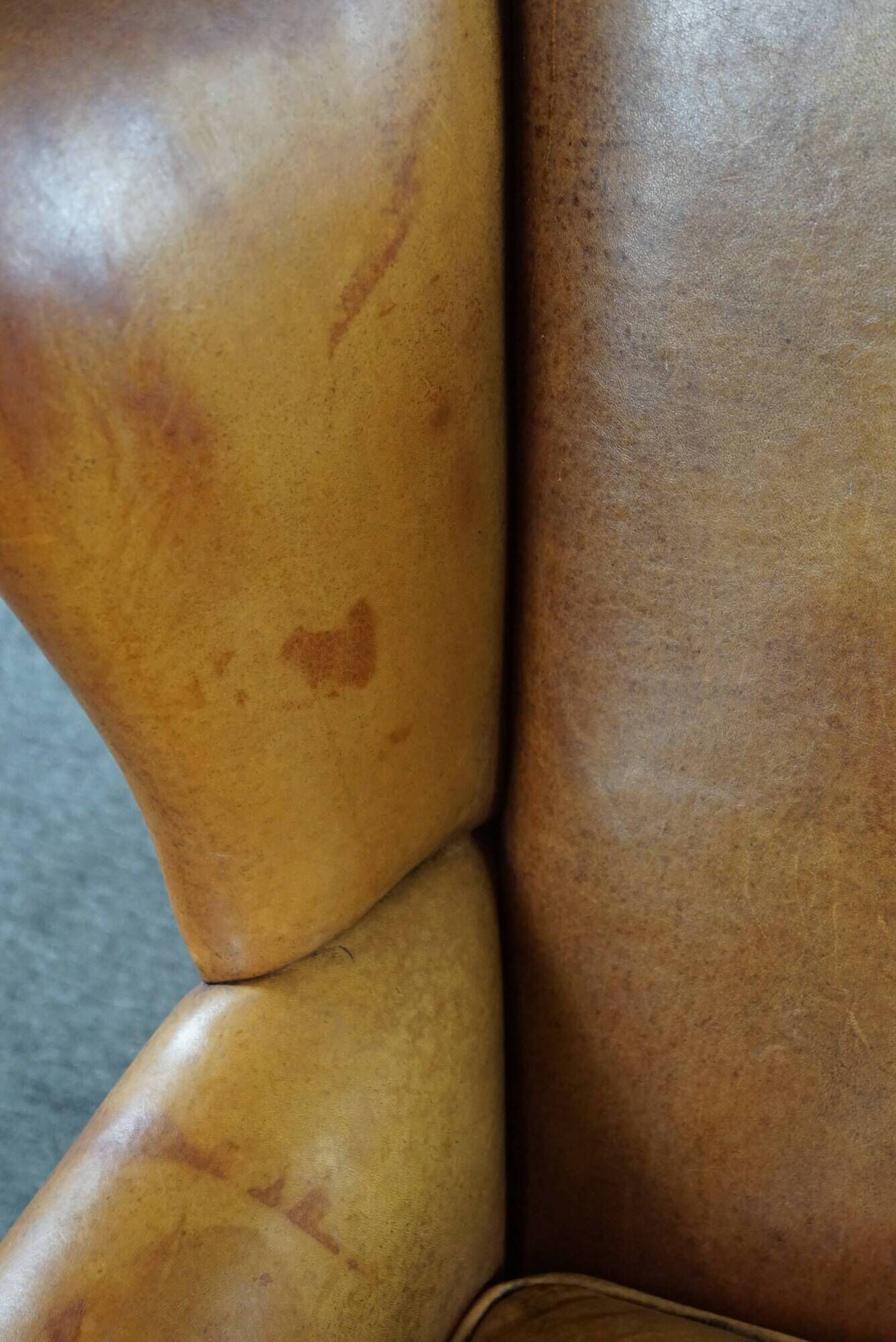 Wingback chair made of sheepskin leather in a light honey color