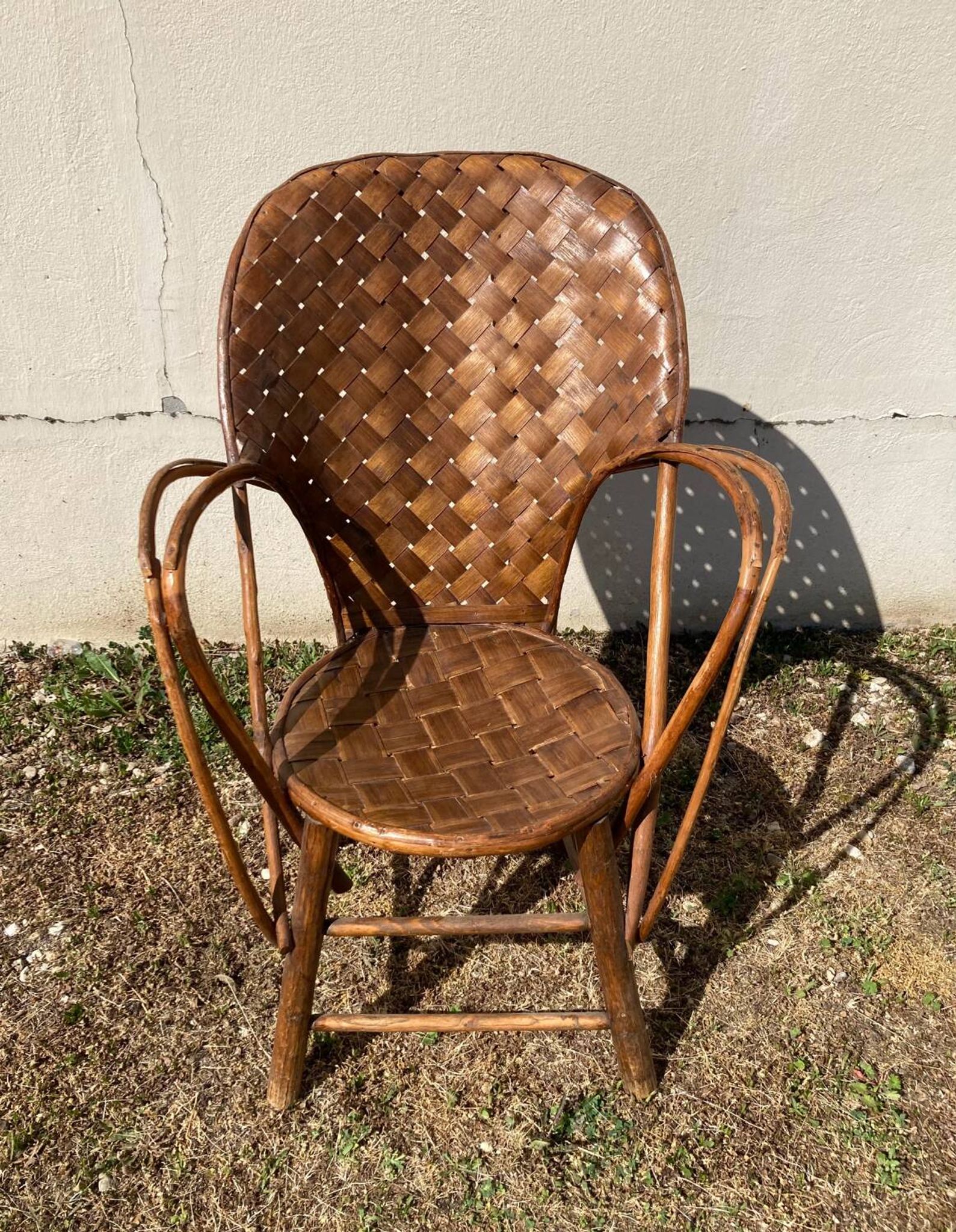 Vintage 1970s armchair in curved woven chestnut + seat cushion