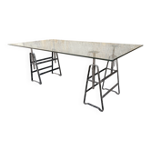 Large vintage industrial glass table with adjustable metal trestles.