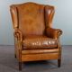 Wingback chair made of sheepskin leather in a light honey color