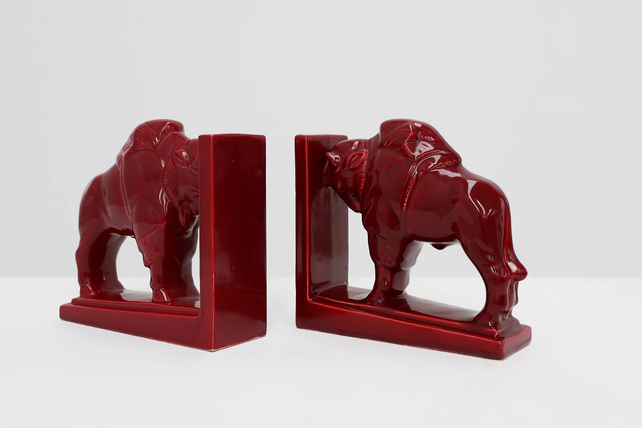 Pair of red glazed ceramic Bison ox bookends in Art Deco style, Belgium