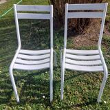 pair of white metal chairs, Tolix style