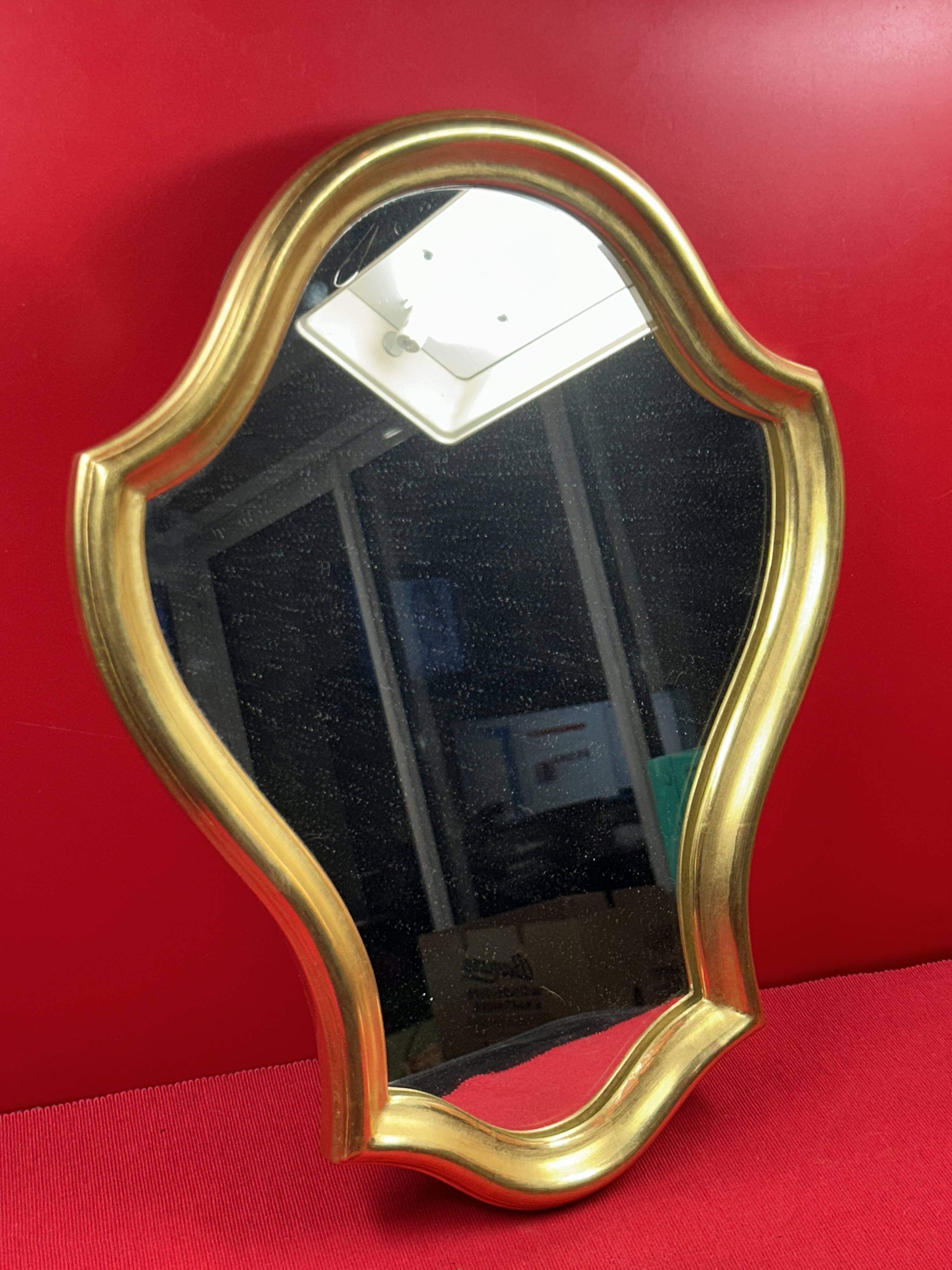 Mirror with a wavy shape, wood and gilded stucco