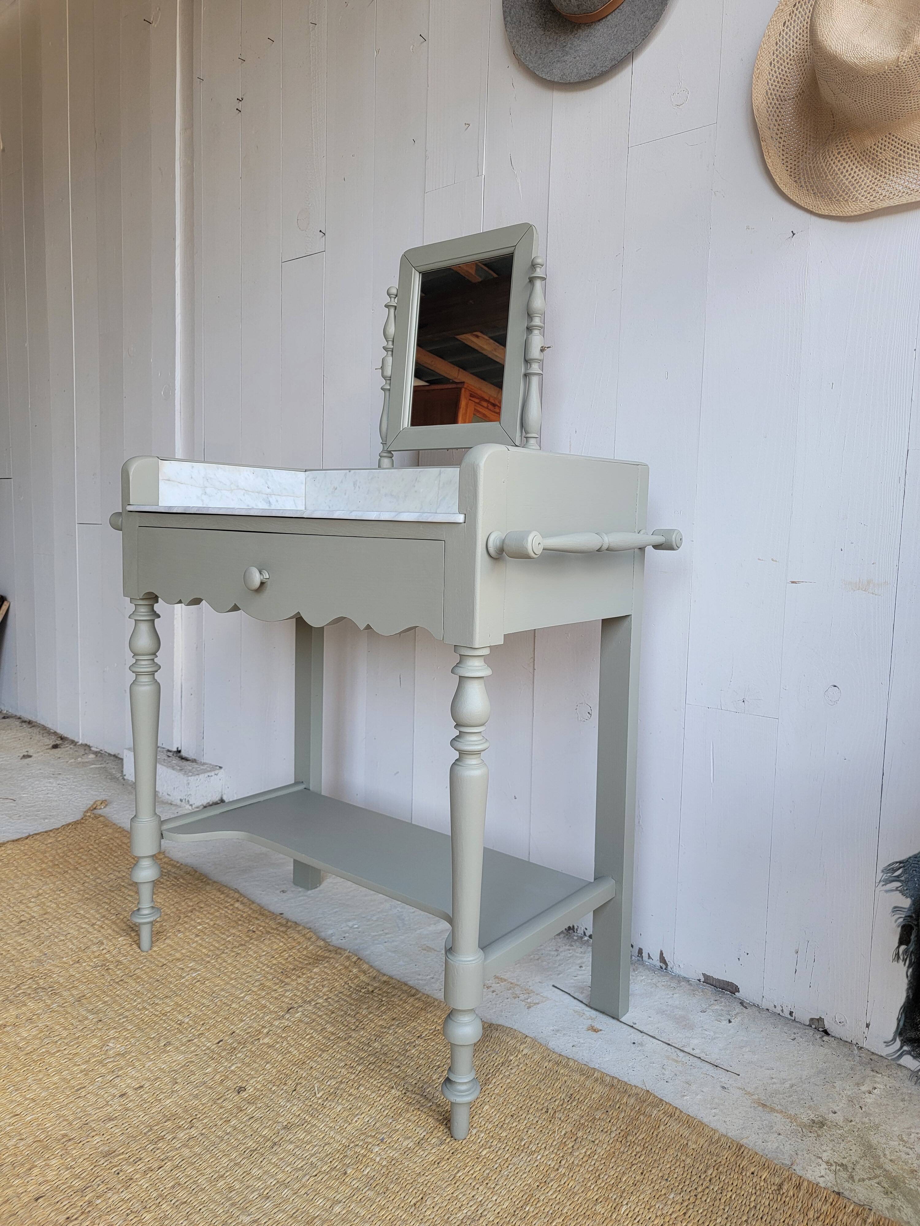 Antique wooden dressing table with marble top and mirror.