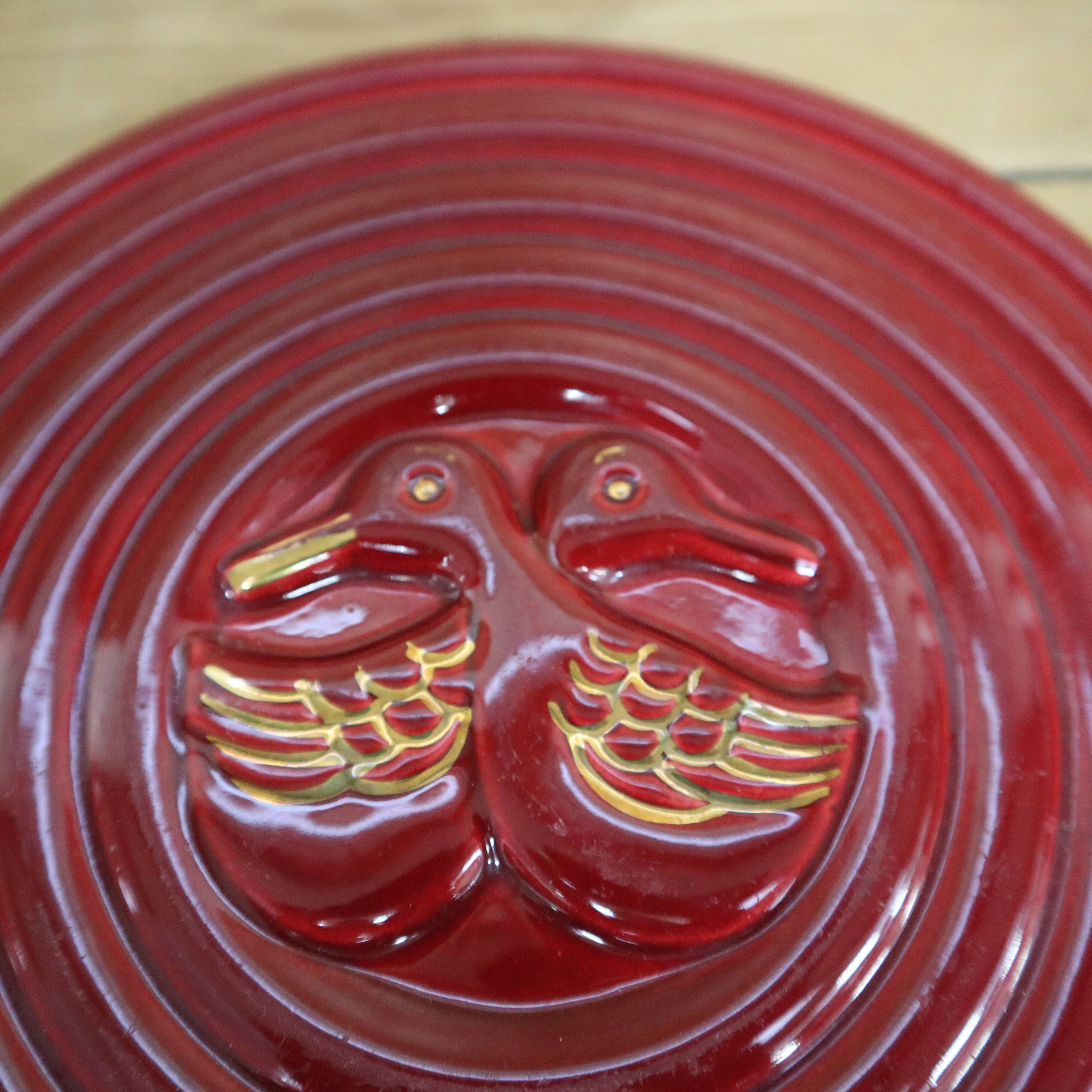 Vintage burgundy duck trivet with gold edging