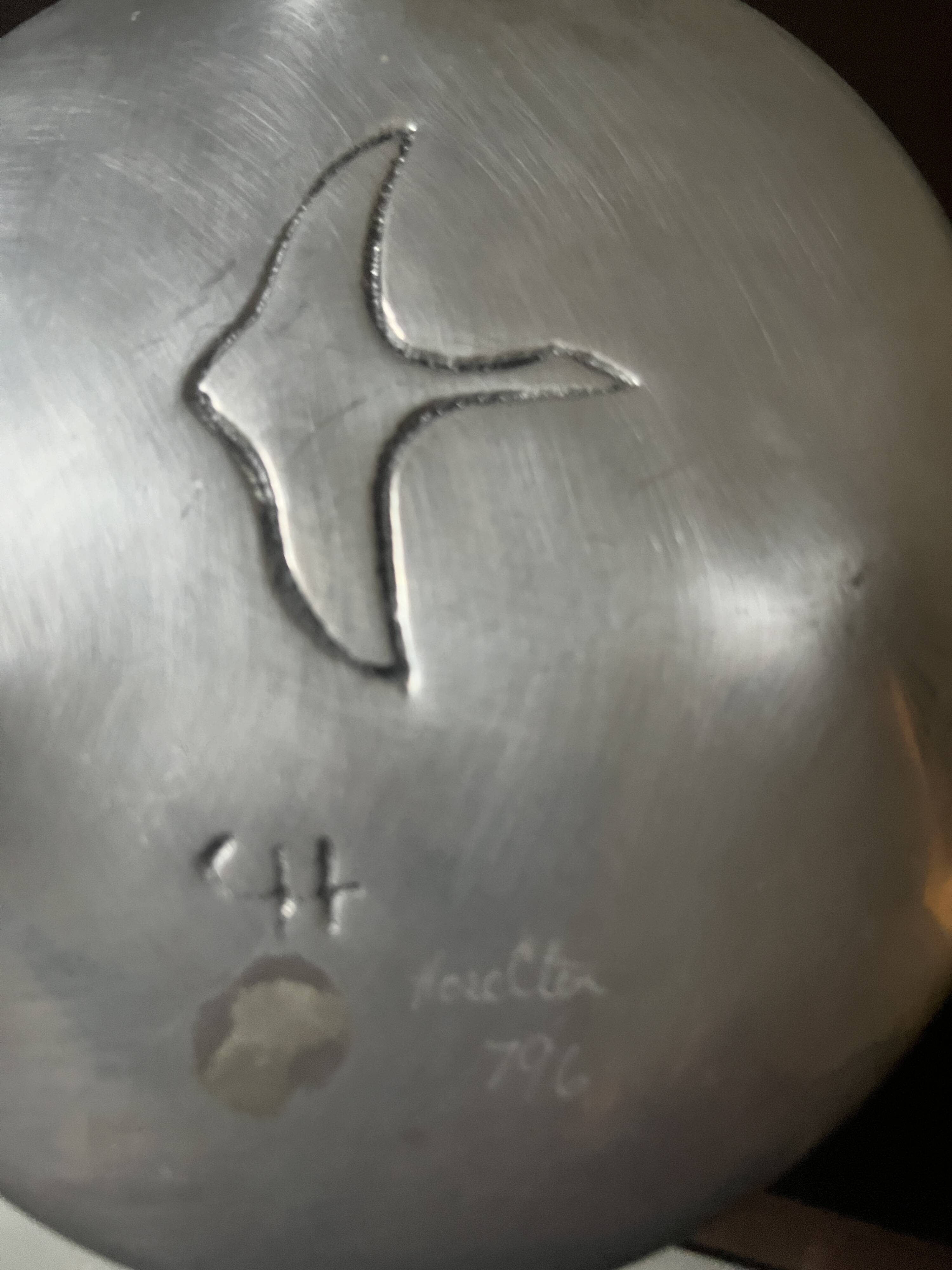 polished aluminum pocket emptier, signed and stamped in the mass