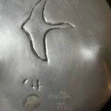 polished aluminum pocket emptier, signed and stamped in the mass