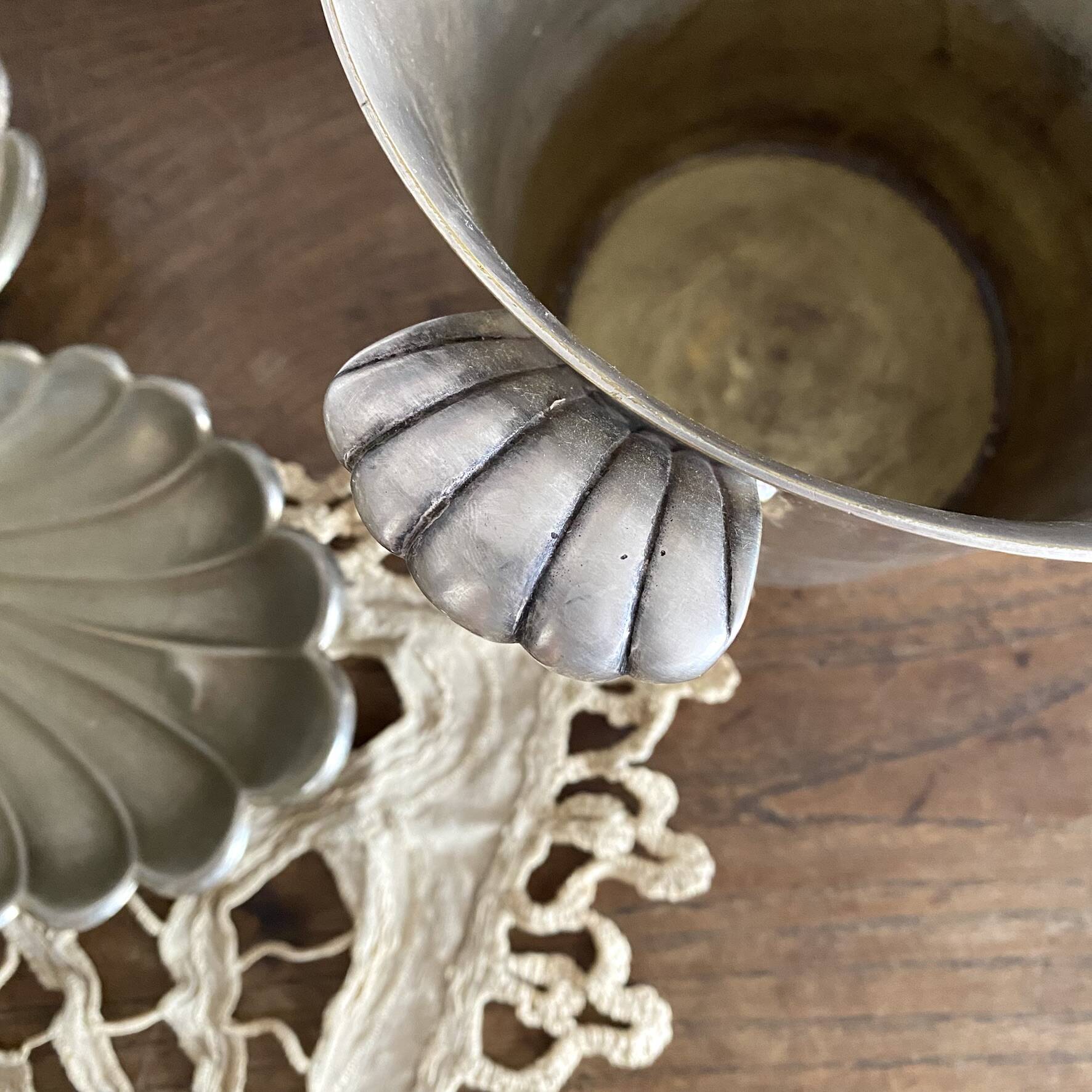 Antique champagne bucket with shell handles.