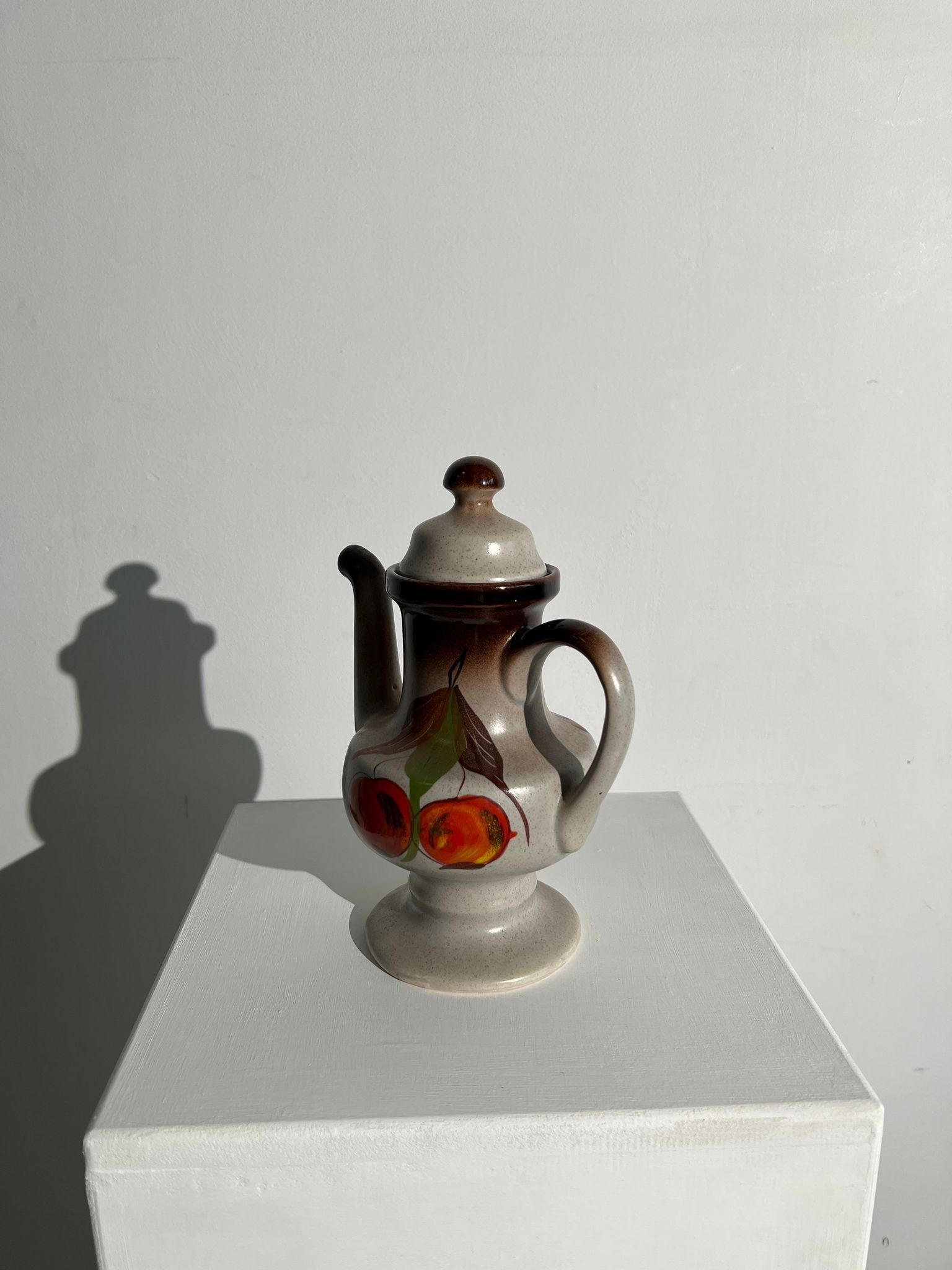 Vintage stoneware teapot with flower and fruit patterns