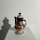 Vintage stoneware teapot with flower and fruit patterns
