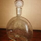 Clear bubble glass bottle molded for easy manual gripping