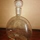 Clear bubble glass bottle molded for easy manual gripping