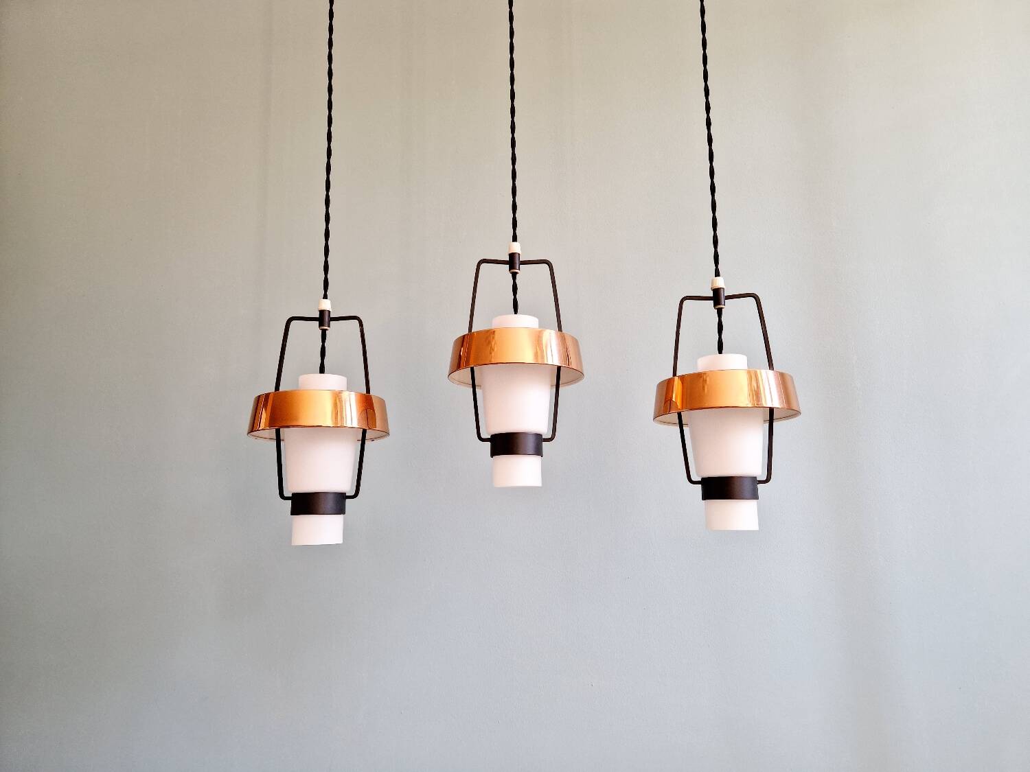 Trio of Scandinavian pendant lights in opaline and copper metal, 1960s