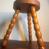 Round tripod stool in carved wood