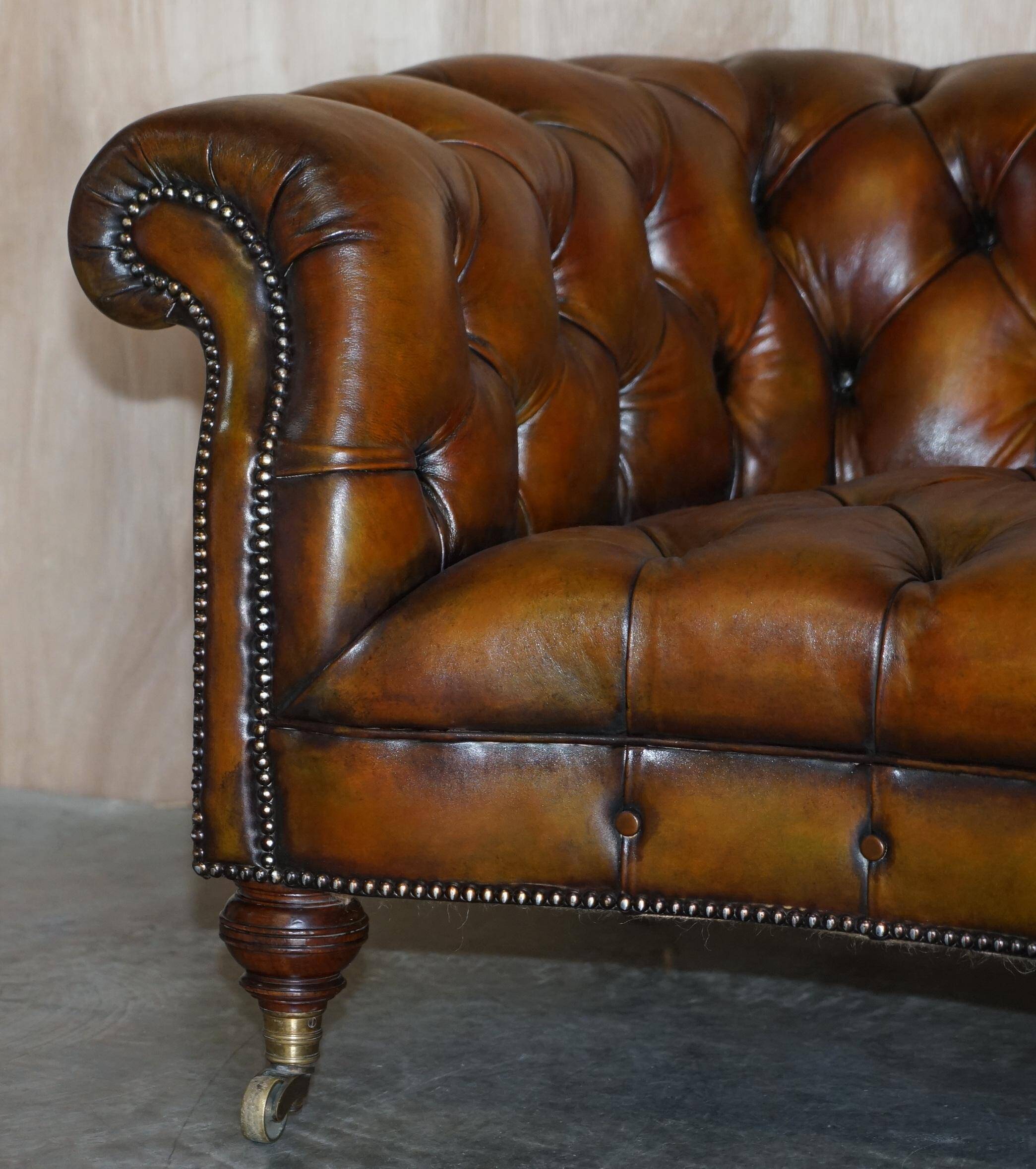 Pair of leather Chesterfield sofas by Howard & Sons