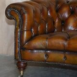 Pair of leather Chesterfield sofas by Howard & Sons
