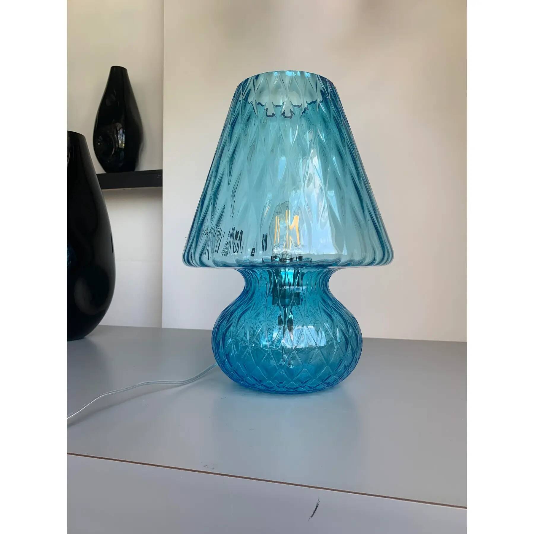 Light blue Murano-style glass with a balloton lamp.