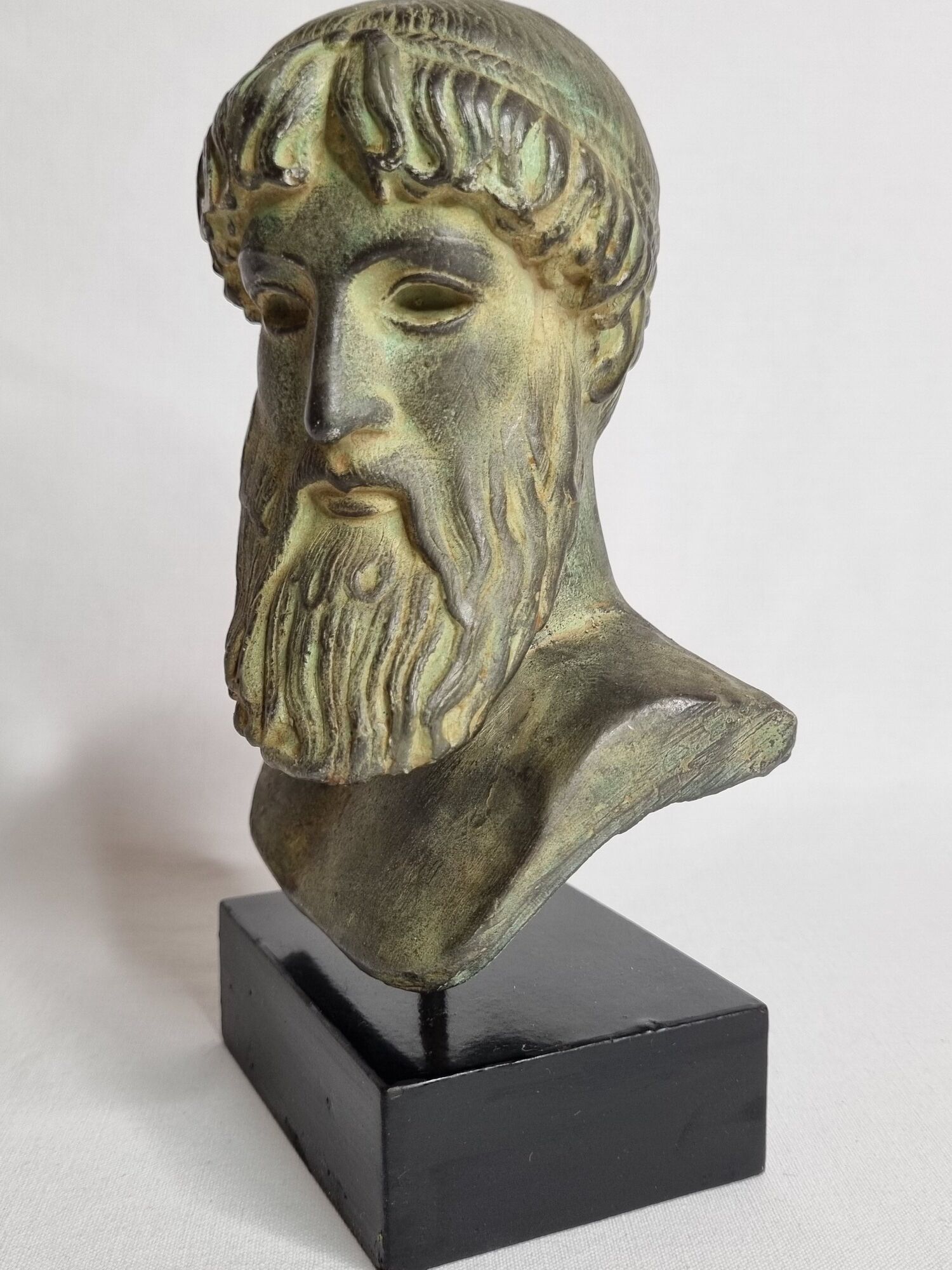 Bust of Poseidon in patinated plaster on wooden base