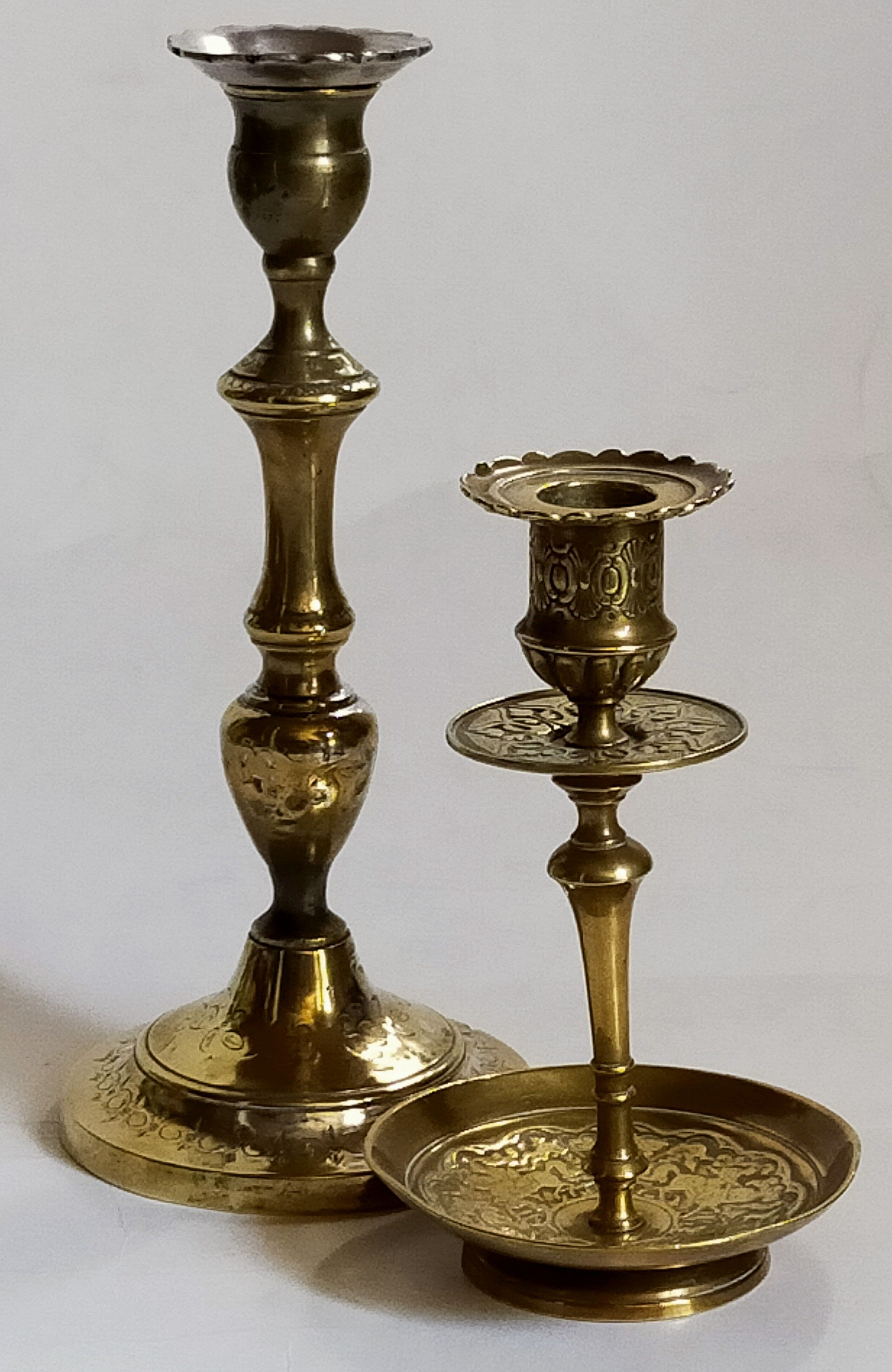 Duo of solid brass and gold metal candle holders worked old