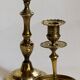 Duo of solid brass and gold metal candle holders worked old