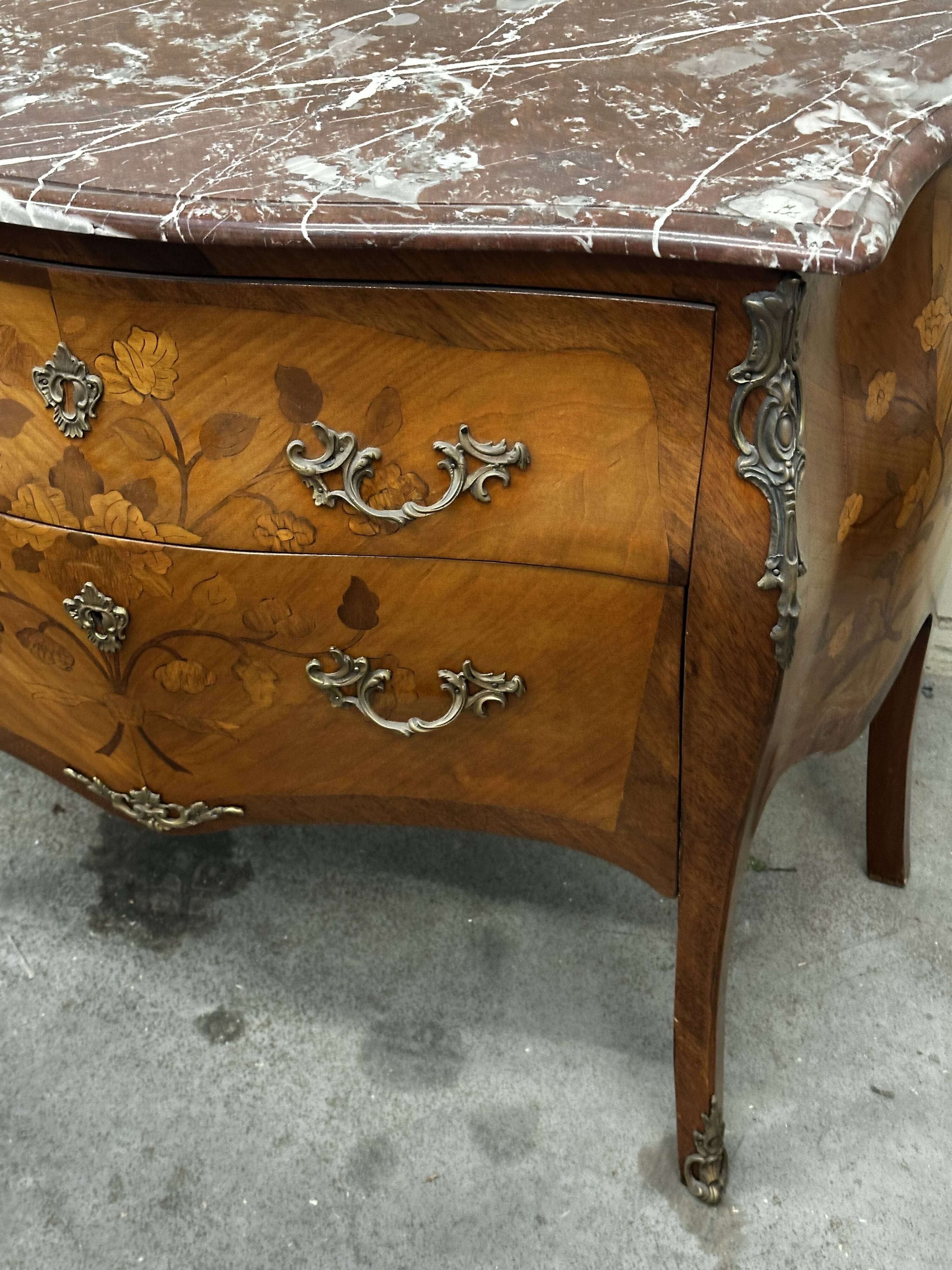Curved and inlaid Louis XV style chest of drawers