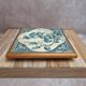 Antique trivet in Gien tile with blue bird decoration – wooden border